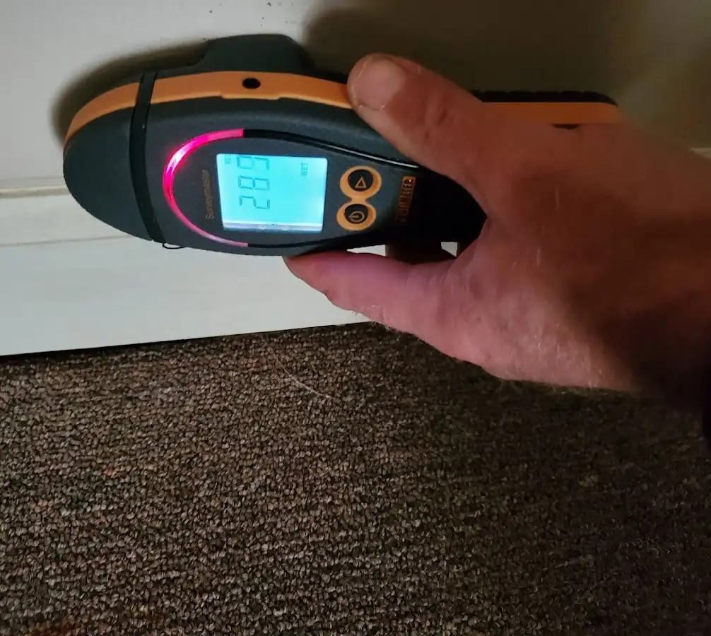 Moisture detection at baseboard during Storm Damage Restoration in Sultan